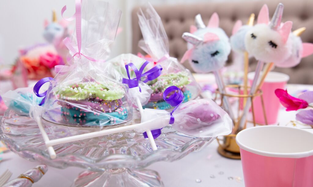 pexels-photo-33261607-33261607 Unicorn-themed birthday party table with colorful treats and decorations.
