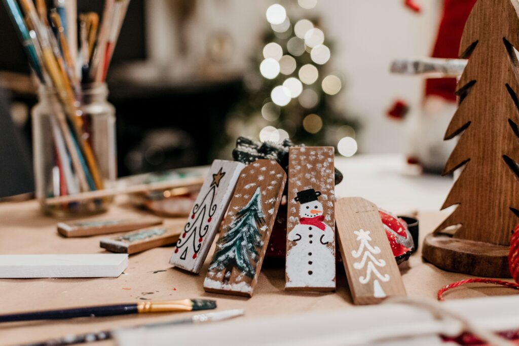 pexels-photo-6163744-6163744 Close-up of hand-painted Christmas wood ornaments with festive bokeh background. Perfect for holiday decor inspiration.